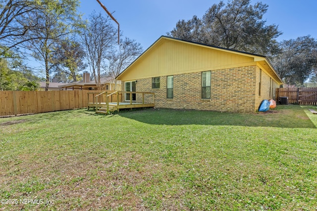 1625 Panther Ridge Ct, Jacksonville, FL 32225 - back of house with a wooden deck, a yard, brick siding, and a fenced backyard