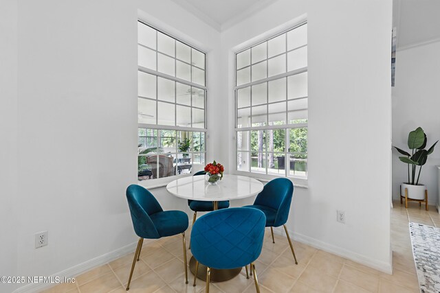 68 Webster Ln, Palm Coast, FL 32164 - dining space featuring baseboards, ornamental molding, and tile patterned flooring