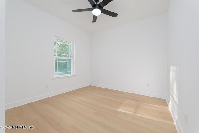 empty room with ceiling fan, baseboards, and light wood finished floors
