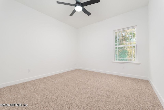 unfurnished room featuring light colored carpet, ceiling fan, and baseboards