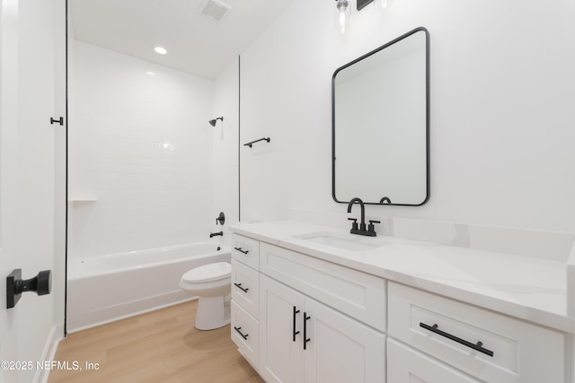 295 SE 57th St, Keystone Heights, FL 32656 - bathroom featuring vanity, toilet, wood finished floors, tub / shower combination, and recessed lighting