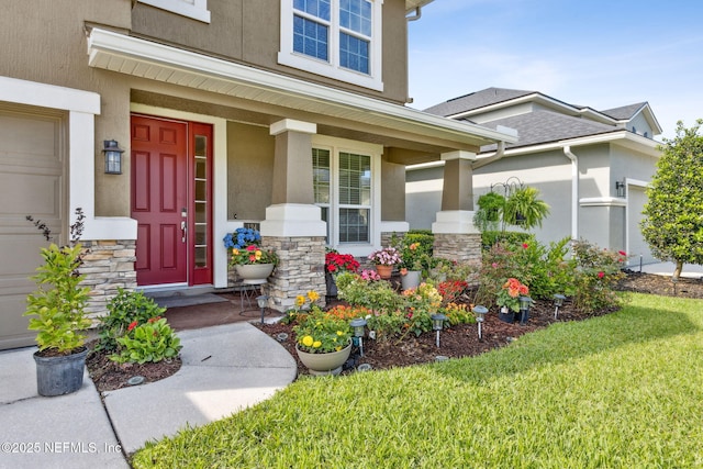 124 Sarah Elizabeth Dr, Saint Johns, FL 32259 - entrance to property with a yard, stone siding, stucco siding, and covered porch