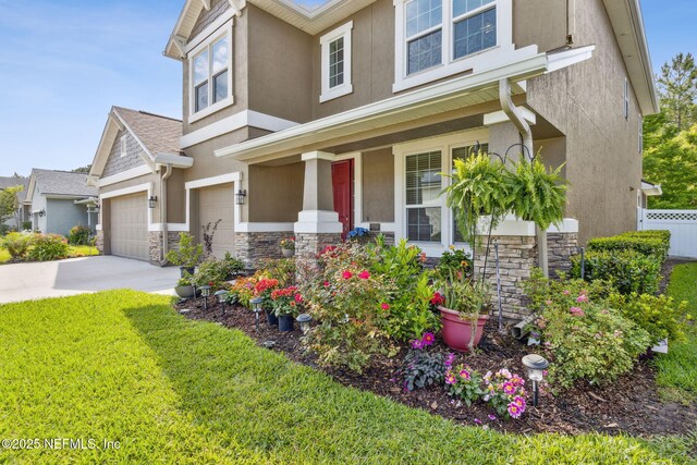 124 Sarah Elizabeth Dr, Saint Johns, FL 32259 - craftsman-style home with stone siding, covered porch, an attached garage, stucco siding, and concrete driveway