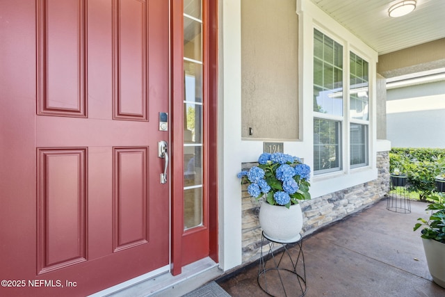 124 Sarah Elizabeth Dr, Saint Johns, FL 32259 - doorway to property featuring covered porch, stucco siding, and stone siding