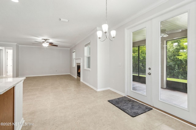 124 Sarah Elizabeth Dr, Saint Johns, FL 32259 - entryway with baseboards, ornamental molding, a lit fireplace, and ceiling fan with notable chandelier
