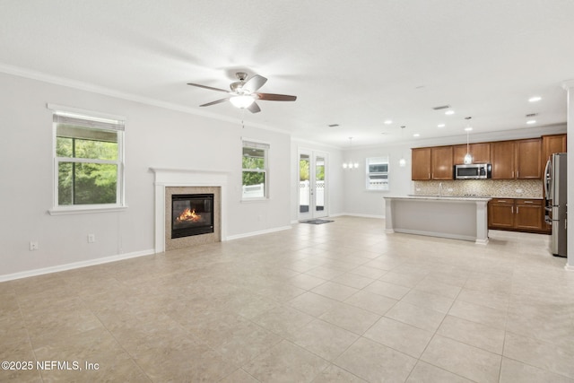 124 Sarah Elizabeth Dr, Saint Johns, FL 32259 - unfurnished living room with a ceiling fan, baseboards, ornamental molding, a glass covered fireplace, and light tile patterned flooring
