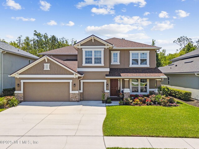 124 Sarah Elizabeth Dr, Saint Johns, FL 32259 - craftsman-style house featuring an attached garage, stone siding, concrete driveway, stucco siding, and a front yard