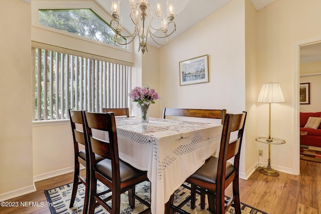 99 Broad River Pl Unit 1301, Welaka, FL 32193 - dining room featuring baseboards, wood finished floors, high vaulted ceiling, and an inviting chandelier