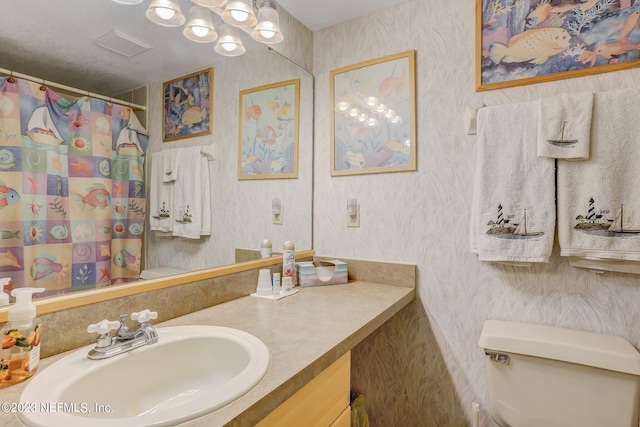 99 Broad River Pl Unit 1301, Welaka, FL 32193 - bathroom with visible vents, vanity, toilet, wallpapered walls, and a notable chandelier