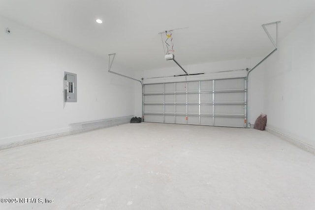 garage featuring electric panel, baseboards, and a garage door opener