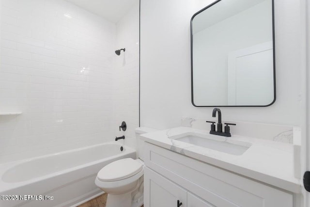 bathroom with wood finished floors, vanity, shower / tub combination, and toilet