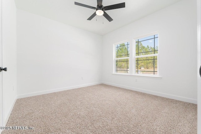 unfurnished room with carpet flooring, baseboards, and a ceiling fan