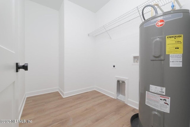 clothes washing area featuring hookup for a washing machine, electric dryer hookup, light wood-type flooring, water heater, and laundry area