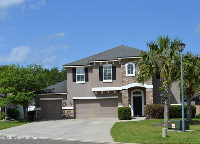 view of front of property with stone siding, stucco siding, concrete driveway, a garage, and a front yard