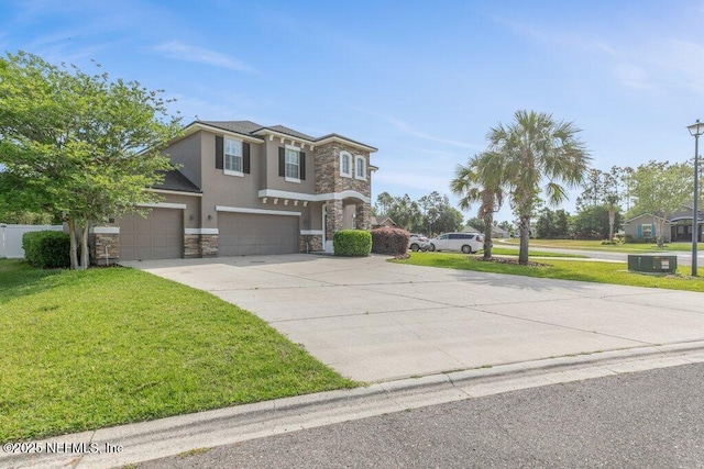 view of front of property featuring stone siding, an attached garage, driveway, a front lawn, and stucco siding