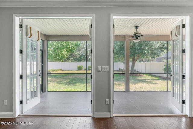 entryway with ceiling fan, wood-type flooring, baseboards, and crown molding