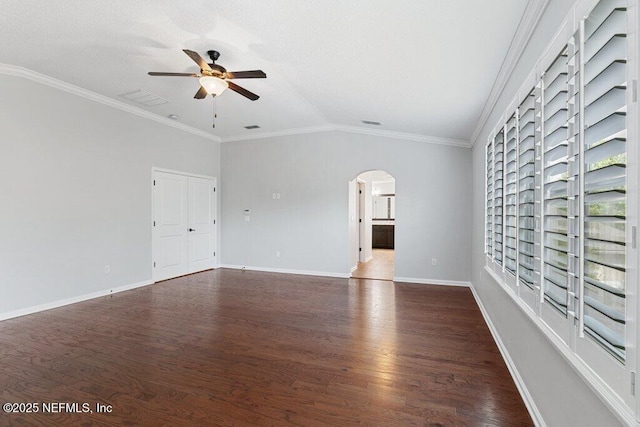 unfurnished room featuring ceiling fan, lofted ceiling, arched walkways, dark wood-style flooring, and baseboards