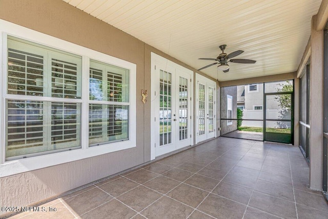 unfurnished sunroom featuring french doors and ceiling fan
