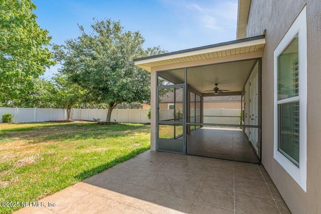 view of patio with a sunroom and a ceiling fan