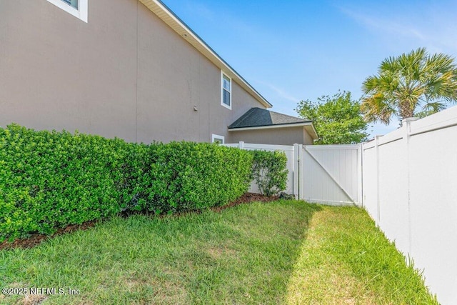 view of yard with a gate