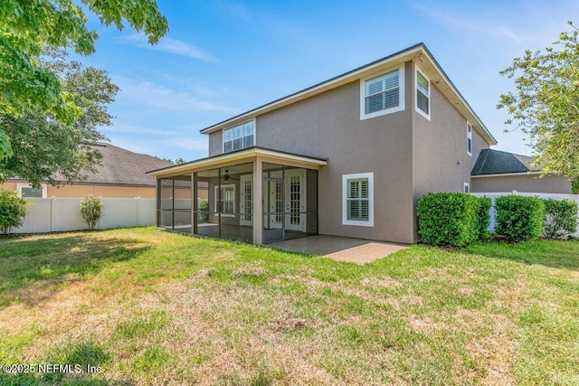 back of house with a sunroom, stucco siding, french doors, and a patio area