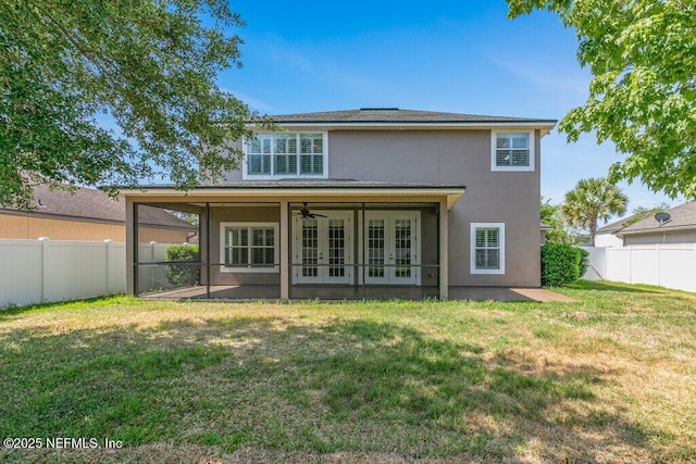 back of property with french doors, stucco siding, ceiling fan, and a patio area