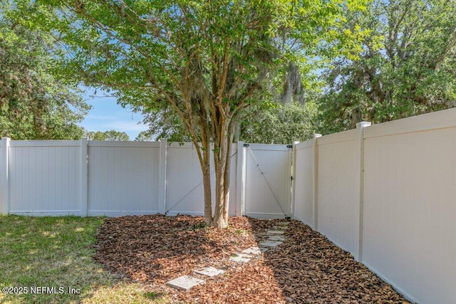 fenced backyard with a gate