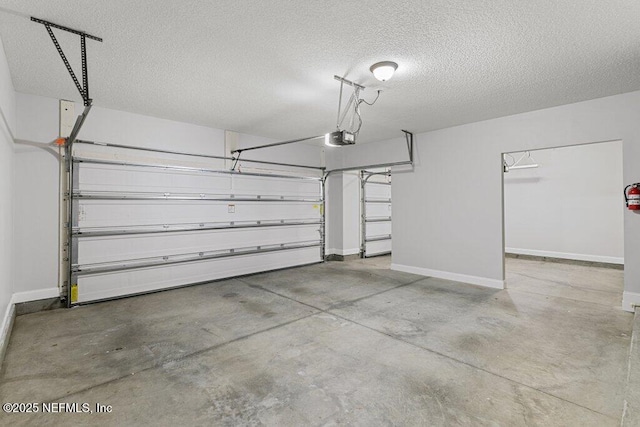 garage with a garage door opener and baseboards