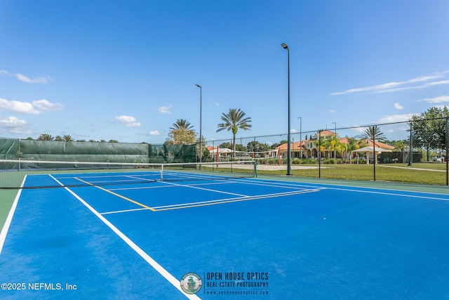 view of tennis court with fence
