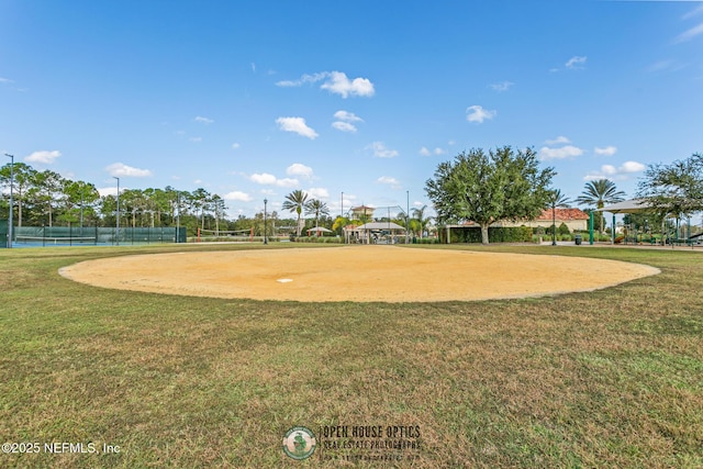 view of property's community with a tennis court