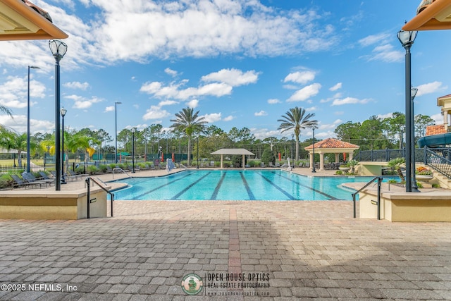 community pool featuring a gazebo, fence, and a patio
