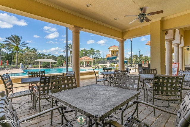 view of patio / terrace with a ceiling fan and a community pool
