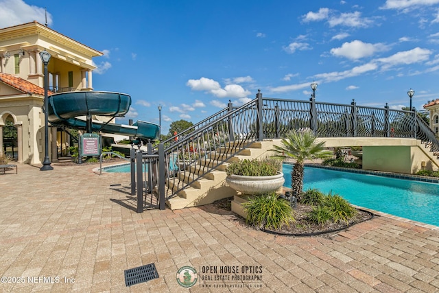 community pool featuring stairway and a patio area