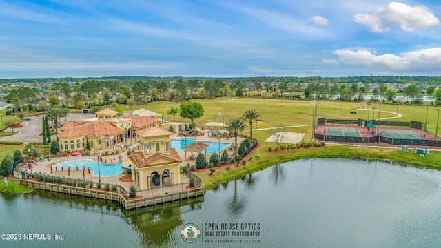 bird's eye view of a pool area and a large body of water