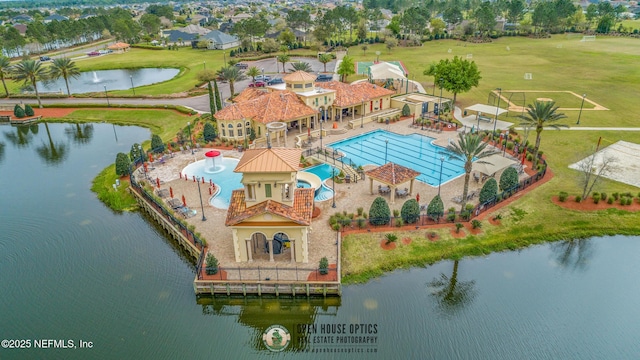 bird's eye view of a pool area and a nearby body of water