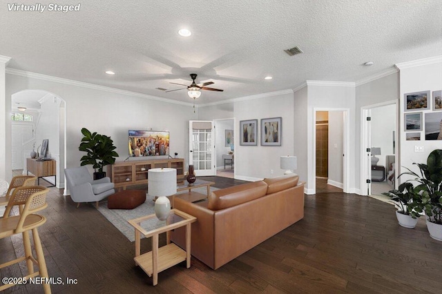 living room with arched walkways, a ceiling fan, wood-type flooring, a textured ceiling, and recessed lighting