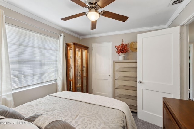 bedroom with visible vents, a ceiling fan, carpet, and crown molding
