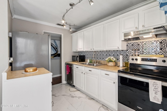 kitchen featuring white cabinetry, a sink, appliances with stainless steel finishes, under cabinet range hood, and ornamental molding