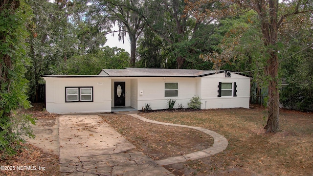 ranch-style home with concrete driveway