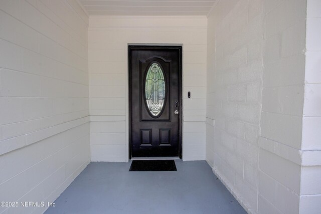 entrance to property featuring concrete block siding