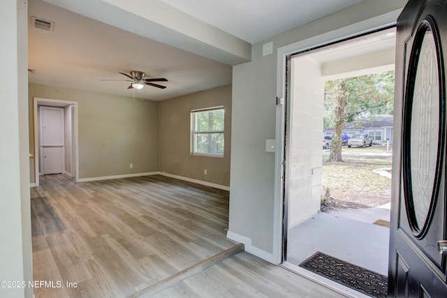 entrance foyer featuring a ceiling fan, visible vents, baseboards, and light wood-style floors