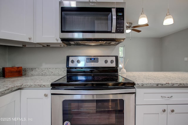 kitchen with stainless steel appliances, a ceiling fan, light stone counters, white cabinetry, and hanging light fixtures