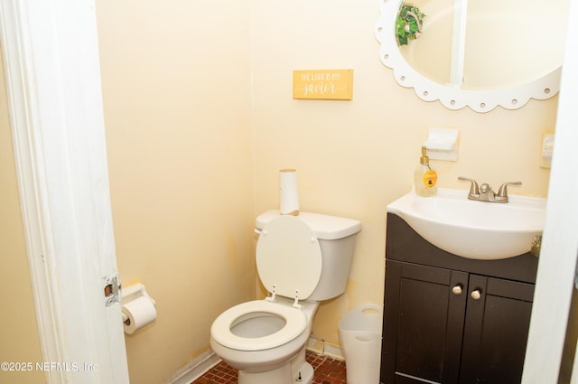 bathroom featuring vanity, toilet, tile patterned flooring, and baseboards