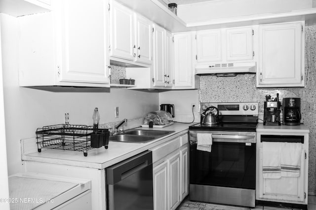 kitchen with stainless steel range with electric cooktop, under cabinet range hood, light countertops, dishwasher, and a sink