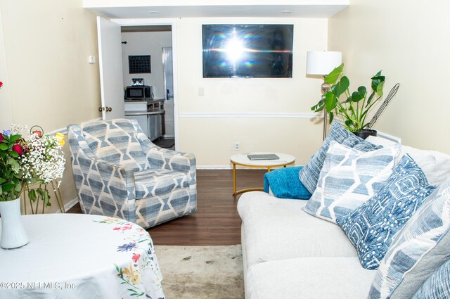 living room featuring wood finished floors and baseboards