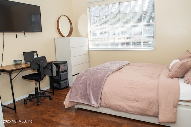 bedroom featuring wood finished floors and baseboards