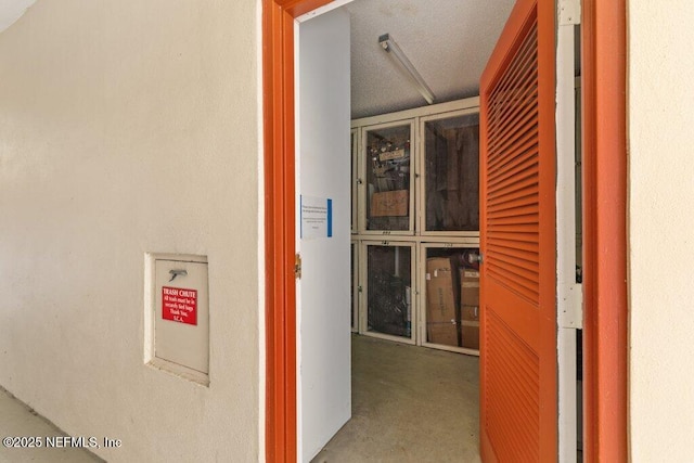hallway featuring unfinished concrete floors