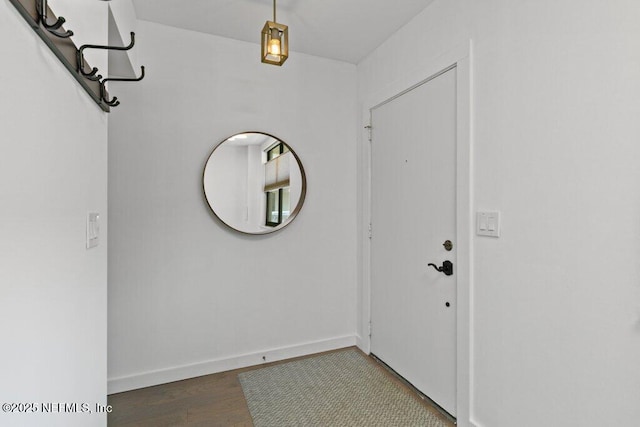 entryway featuring baseboards and wood finished floors
