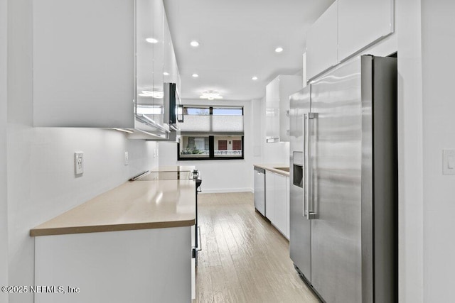kitchen featuring white cabinets, appliances with stainless steel finishes, light wood-style floors, recessed lighting, and modern cabinets