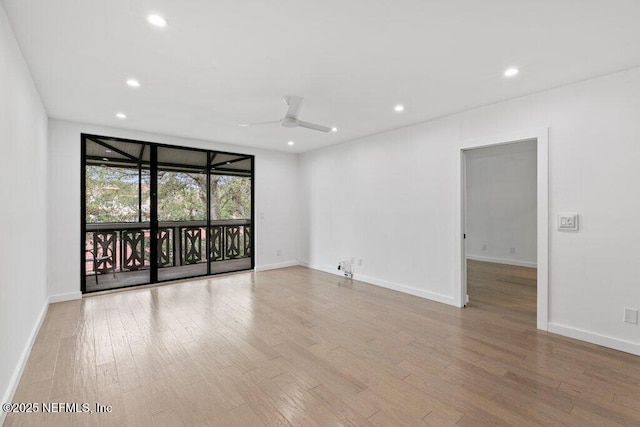 spare room featuring a ceiling fan, baseboards, recessed lighting, and wood finished floors